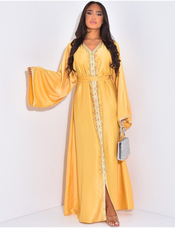 Premium Abaya aus Satin mit handgenähten Kristallen und goldener Einfassung.