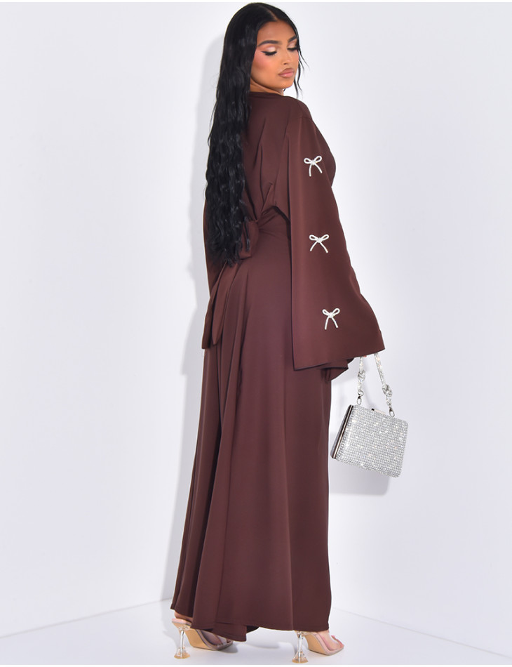 Flowing abaya with shiny bows on the sleeves